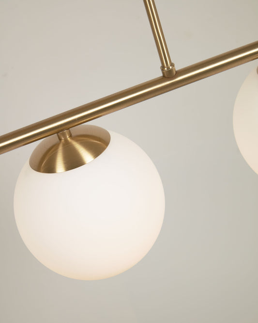Mahala ceiling light with steel detail and brass finish and three frosted glass spheres